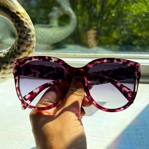 Purple tortoise framed sunglasses